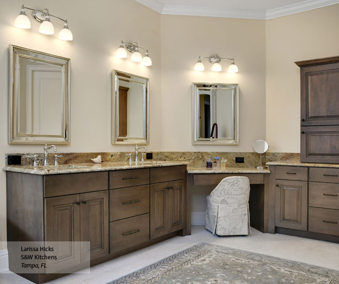 Traditional cherry wood kitchen cabinets with raised panel doors and decorative crown molding